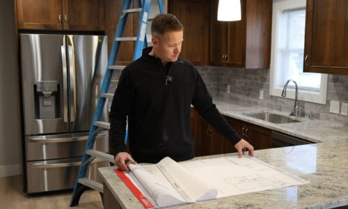 picture of man viewing the house plan - custom home builder